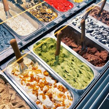 Artisanal gelato with various flavors on display.